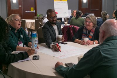 Conference attendees participating in table activity