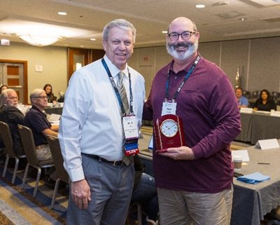 Mark Harms congratulates Mark Christ after the latter's nine years of service on the IASB Board of Directors.