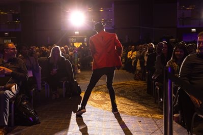 Photo of Mickey Smith Jr. performing for Conference attendees